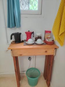 a wooden table with a coffee maker on top of it at Sidi Bou House in Sidi Bou Saïd +13 photos
