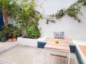 an outdoor patio with a table and potted plants at Sidi Bou House in Sidi Bou Saïd