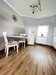 a living room with a table and a refrigerator at Strandperle in List +3 photos