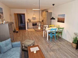 a living room and kitchen with a table and chairs at Walfisch im Zentrum - ABC350 in Wismar