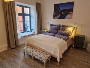 a bedroom with a large bed and a window at Walfisch im Zentrum - ABC350 in Wismar +16 photos