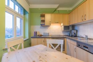 a kitchen with a wooden table and a counter top at Haus Tarnewitz, Ferienwohnung 06 in Tarnewitz