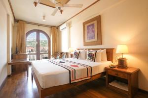 a bedroom with a large bed and a window at Hotel Casamara in Kandy +28 photos