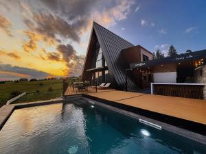 a house with a swimming pool in front of a building at Euphoria - luxury villa in Vlasic +73 photos