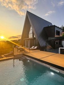 a house with a swimming pool next to a building at Euphoria - luxury villa in Vlasic