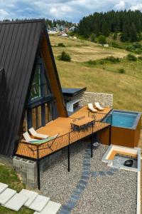 a house with a deck and a swimming pool at Euphoria - luxury villa in Vlasic