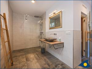 a bathroom with a sink and a mirror at Fischerdorf Zirchow Seebär in Zirchow +19 photos