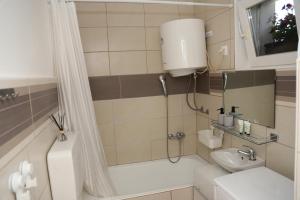 a bathroom with a shower and a toilet and a sink at Studio apartman IVAN in Karlovac +35 photos