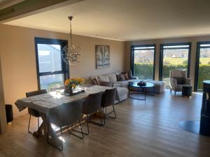 a living room with a table and a couch at Enebolig på Nesbrygga in Nesbrygga