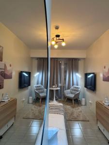 a bedroom with a bed and a table and chairs at Queen's Escape in Manila +8 photos