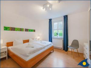 Ein Bett oder Betten in einem Zimmer der Unterkunft Villa Margot Whg 26