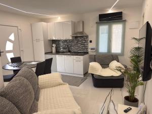 a living room with a couch and a kitchen at Apartments Lollipop in Novi Vinodolski