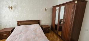 a bedroom with a bed and a mirror at Casa Villa in Baku