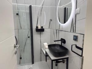 a bathroom with a black sink and a shower at Apartments Lollipop in Novi Vinodolski +48 photos