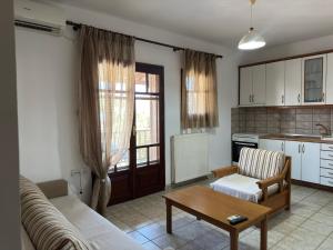 a living room with a couch and a table at Zafiroudis Apartments in Nikiti