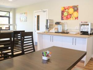 a kitchen with a counter and a table with chairs at The Lifeboat Landing at Marine Court in Littlehampton +11 photos