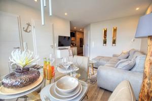 a living room with a couch and a table at Ferienpark - Haus K, App 0K0801 in Heiligenhafen