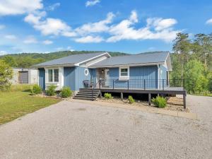 a blue house with a porch and a driveway at FLAT Lakefront Home w/ Dock-Kayaks-Paddle Board in Sandlick