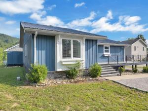 a home with a blue and white house at FLAT Lakefront Home w/ Dock-Kayaks-Paddle Board in Sandlick +63 photos