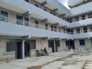 a motorcycle parked in front of a building at Naiposha Studios CN in Munyu