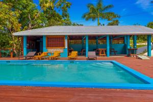 a swimming pool in front of a house at Manana in French Harbor