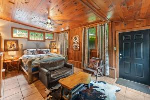a bedroom with a bed and a chair at North 40 Lodge and Cabin in Clarkesville