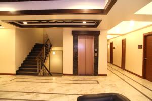 a hallway of a building with stairs and a door at Amantra Comfort Hotel in Udaipur