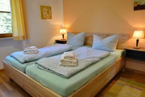 a bedroom with two beds with towels on them at Ferienresidenz Chiemseestrand - Apartment 14 in Chieming