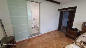 a bathroom with a glass shower and a toilet at Country House La Villa in Villadossola