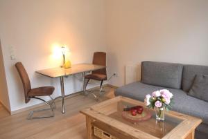 a living room with a couch and a table at Seepassage Ferienwohnung Nr 02 in Timmendorfer Strand
