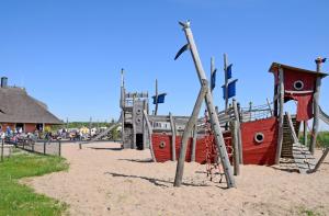 a playground with a pirate ship on the beach at Appartementhaus mit Meerblick im Ostseebad Göhren HO in Göhren