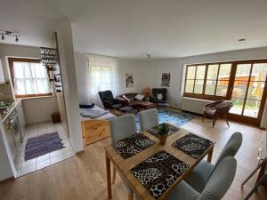 a kitchen and living room with a table and chairs at Ferienwohnungen im Feriendorf Reichenbach Nr 9 in Nesselwang