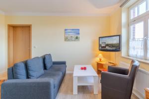 a living room with a couch and a table at Haus Tarnewitz, Ferienwohnung 05 in Tarnewitz