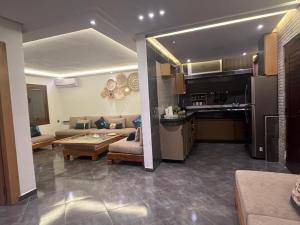a kitchen and a living room with a couch and a table at House near beach in M'diq