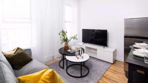 a living room with a couch and a table at Spacious 3BR Retreat Near Times Square in New York