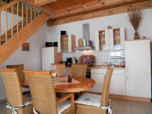 a kitchen and dining room with a table and chairs at Ferienpark Neppermin Appartmenthäuser in Neppermin +61 photos