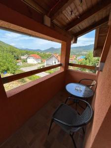 a balcony with a table and a chair on it at Apartman Franjicic in Korenica