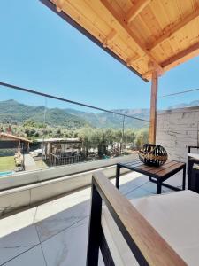 a view from the balcony of a house with a table at Rainbow Apartments in Skala Potamias
