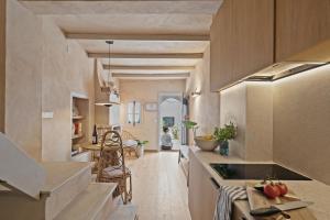 a kitchen with wooden cabinets and a dining room at Casa Casco Antiguo Altea - La Toalla in Altea
