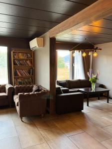 a living room with two couches and a table at Vossestølen Hotel in Vossestrand