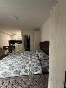 a bedroom with a large bed and a kitchen at Perfect place 4 Djenovici in Đenovići