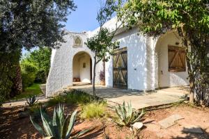 a white house with a large door and trees at Jacuzzi Artistic Villa in Nea Makri in Nea Makri