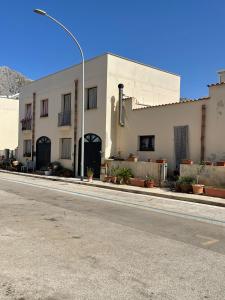 a white building on the side of a street at Casa Joe in San Vito lo Capo