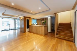 a room with a staircase and a lobby with wooden floors at Loi Flats Buenos Aires in Buenos Aires