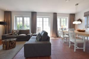 a living room with a couch and a table at Ferienhaus Hannah in Morsum