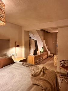 a bedroom with a large bed and a staircase at Casa Altea Casco Antiguo in Altea