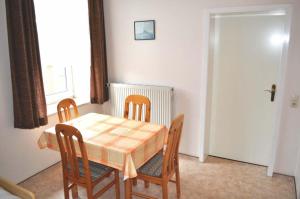 a dining room with a table and chairs and a window at Hof Kröger Ferienwohnung Nr 04 in Travemünde