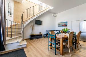 a dining room with a table and a staircase at Château Féger 5 suites in Camblanes-et-Meynac