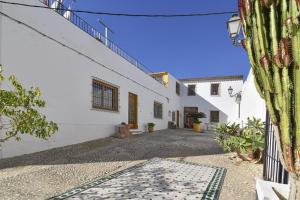 an alley with a white building and a cactus at Casa Altea Casco Antiguo in Altea
