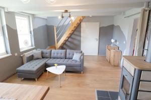 a living room with a couch and a table at Ferienhaus Schnitterkarten - nur an Feriengäste - ABC366 in Klütz